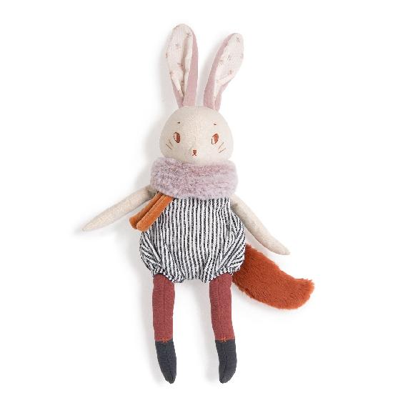 On a white background, a plush bunny with a foxes tail. Muted colours a black and white striped romper with a soft furry neckwarmer.