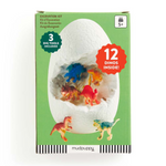 Mudpuppy Excavration Kit in a green box, featuring a large white dinosaur egg graphic with colorful toy dinosaurs inside and printed text indicating 3 dig tools and 12 dinosaurs included.