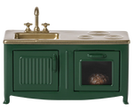 Green kitchen stove with sink and gold faucet on a white background