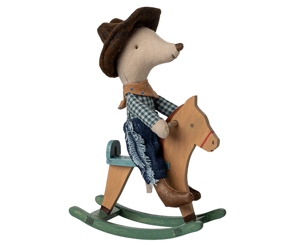 Toy mouse in cowboy outfit riding a wooden horse on a white background