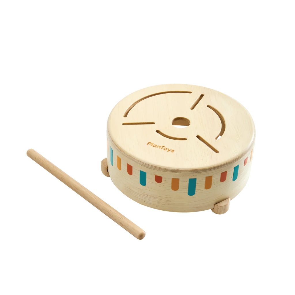 Wooden drum with colorful stripes and a drumstick on a white background, branded 'planToys'.