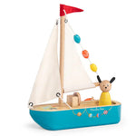 Toy sailboat with a teddy bear on a white background