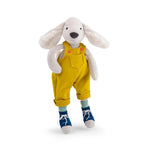 Stuffed animal white dog  with yellow overalls and blue shoes on a white background