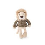 A cream-coloured lion with a short mane wearing a knit sweater on a white background