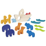 Colorful wooden animal toys around a white boat on a white background