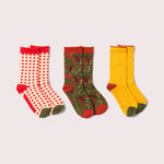 Three pairs of colorful socks on a light gray background