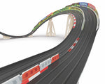 Model of a slot car racing track with curves and straight sections on a white background
