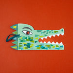 Colorful paper alligator craft on a red background