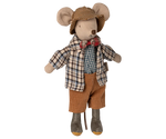 Stuffed mouse toy dressed in a plaid shirt, bow tie, and brown pants on a white background