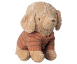 Stuffed dog toy wearing a knitted sweater on a white background