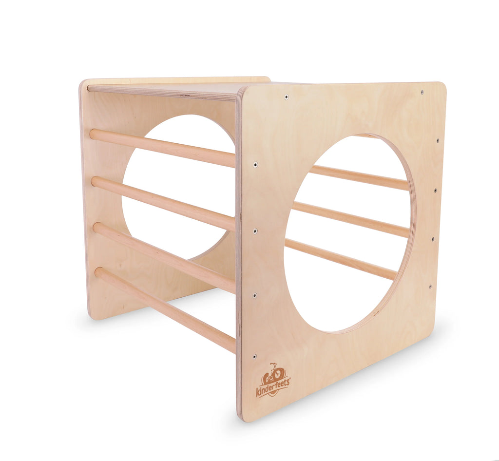 Square wooden climbing toy with circular and rectangular holes on a white background