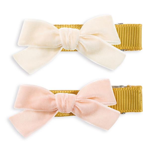 on a white background, two hair clips with velvet bows 