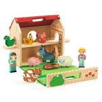Wooden toy farm set with animals and figures on a white background