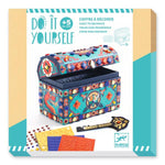 Decorative chest with art supplies on a white background