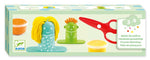 Children's hairdressing workshop set with dolls and tools on a green box, featuring Djeco branding.