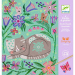 Children's scratch art book with a cat, flowers, and butterflies on a light blue background.