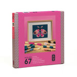 A pink box on a white background with a picture of aframed needlepoint butterfly and embroidery thread. Atelier 67 is on the front of the box.