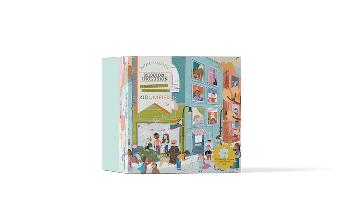 The Square puzzle box at an angle. Box is illustrated with soft colours showing lots of kids of different colours and abilities on a street in front of an apartment building and in the windows of the apartment building.