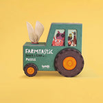 Green puzzle box shaped like a tractor on a yellow background
