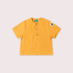 Yellow shirt with a small patch on a light gray background
