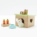 Wooden toy set with a hamster-like figure, a box, and small carrots on a white background