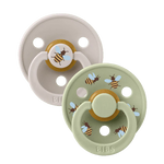 Two baby pacifiers with bee designs on a white background