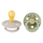Two baby pacifiers, one yellow and one with bee design, on a white background