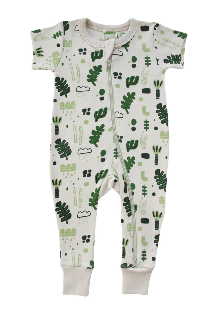 off-white one-piece romper with off-white zipper from foor to neck. All over print consisting of dark green and light green organic leaf shapes, some outlined, some filled