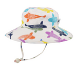 A white sunhat with a wide brim and a strap that hangs down with a toggle tie on a white background. Different colors of large koi fish are all over the hat