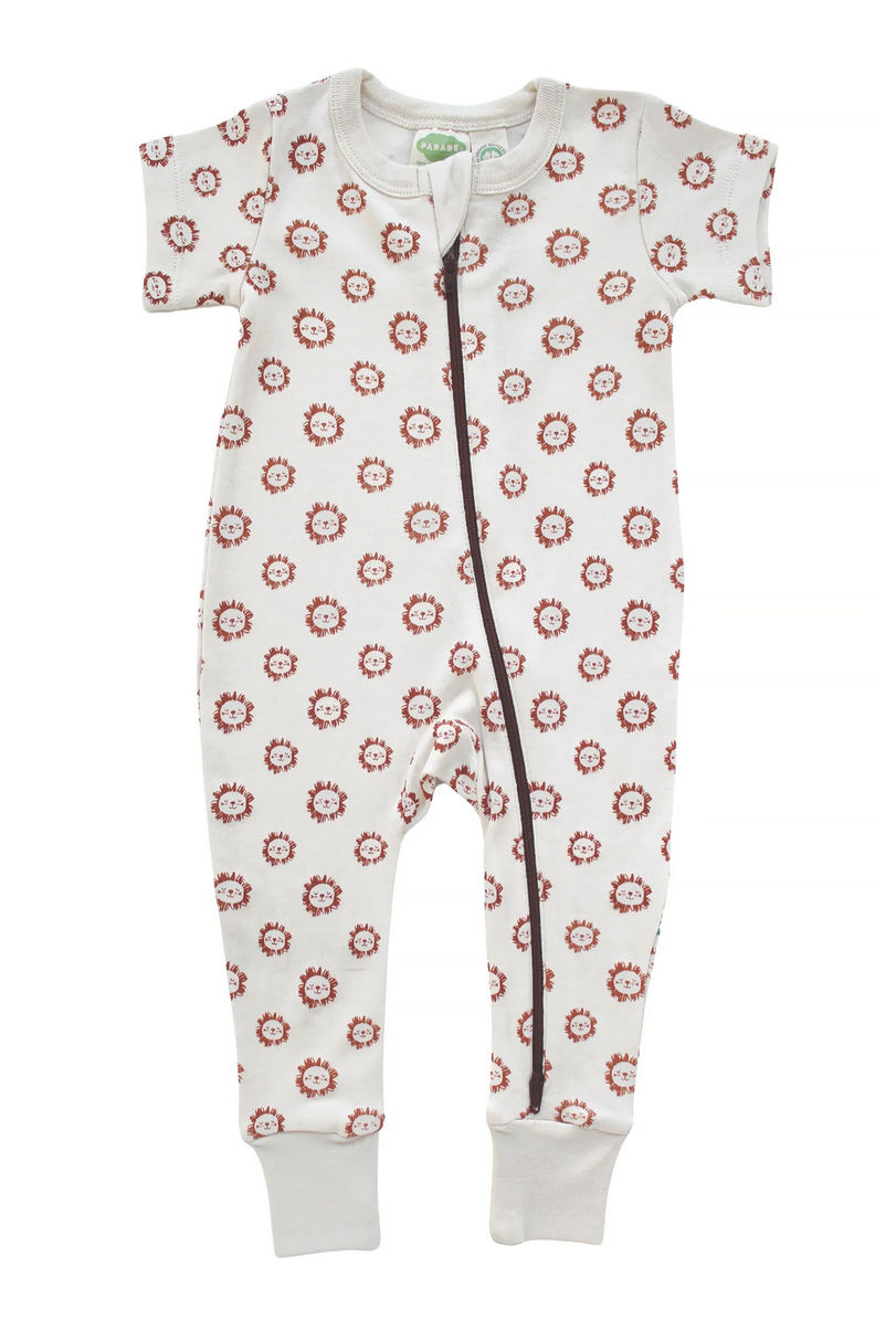 off-white one-piece romper with dark orange zipper from foot to neck on a white background. Orange outline illustrations of circular lion heads in a uniforn all-over print