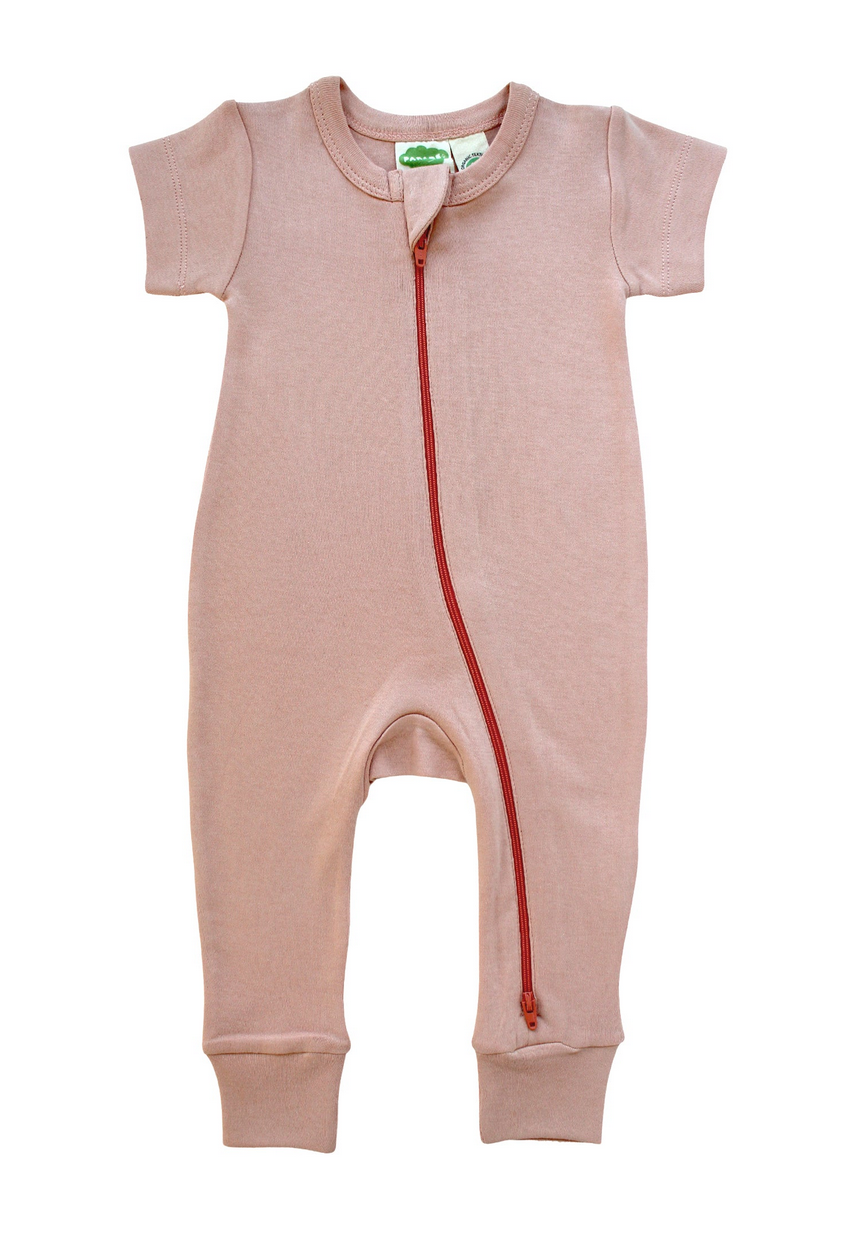 short-sleeve pink one-piece romper with dark pink zipper from foot to neck flat on a white background