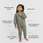 Child wearing a green onesie with text highlighting features on a white background