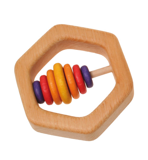 A wooden hexagon teathing ring with seven coloured wooden discs in purple, red and yellow on a white background.