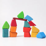 a stack of organically shaped colourful wooden blocks in a white setting