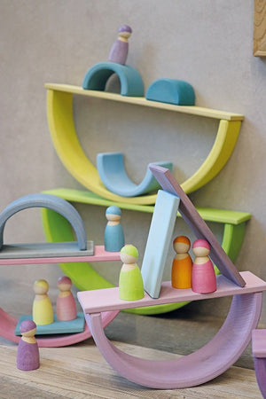 an interior picture of wooden arcs, planks and peg people balancing on different structures