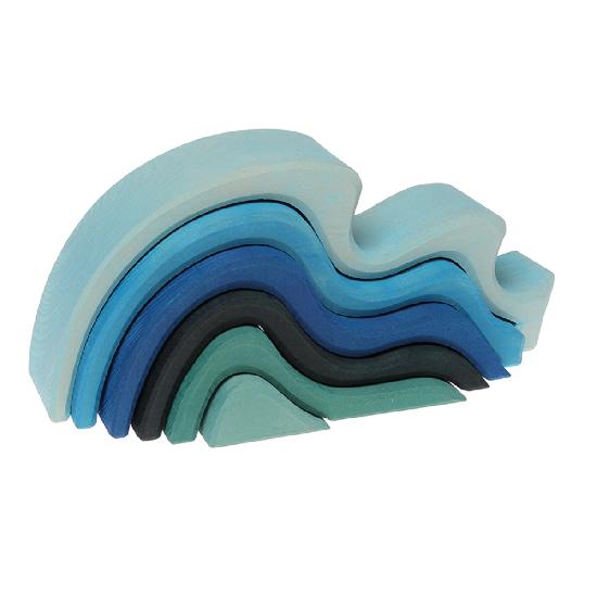 wooden waves in various shades of blue nested into each other on a white background