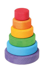 On a white background, a small wooden stacking tower with rings in rainbow colours