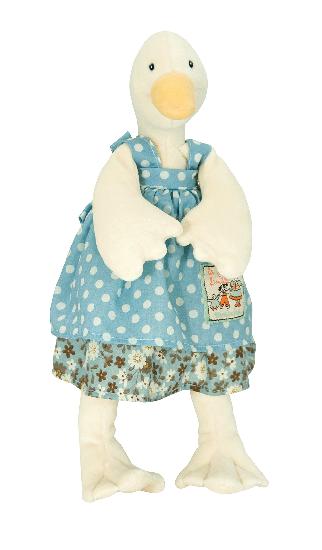 On a white background, a plush white duck in a blue polka dot dress with a floral ruffle at the hem