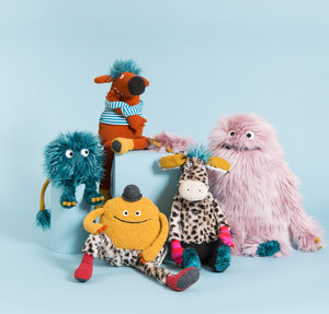 In a blue room, a bunch of colourful plush characters 