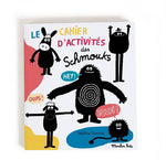 On a white background, a book with splotches of colour and illustrated black and white monsters