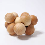 12 natural wooden balls connected with an elastic on a white background.