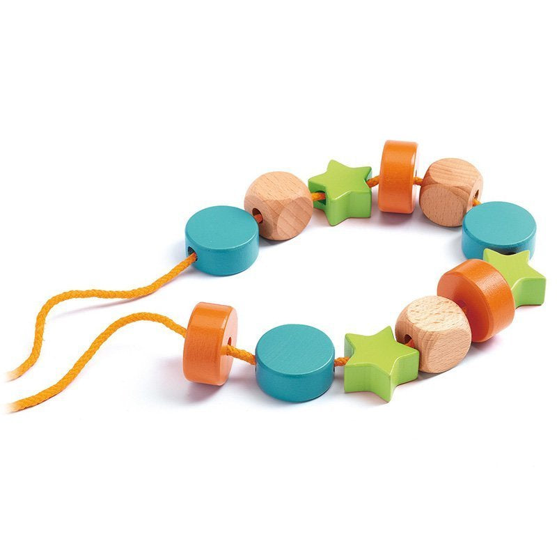 An orange string with some of the multi-coloured beads laced onto it over a white background.