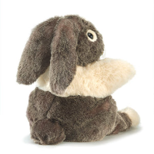 the back of a brown and cream plush dutch bunny on a white background