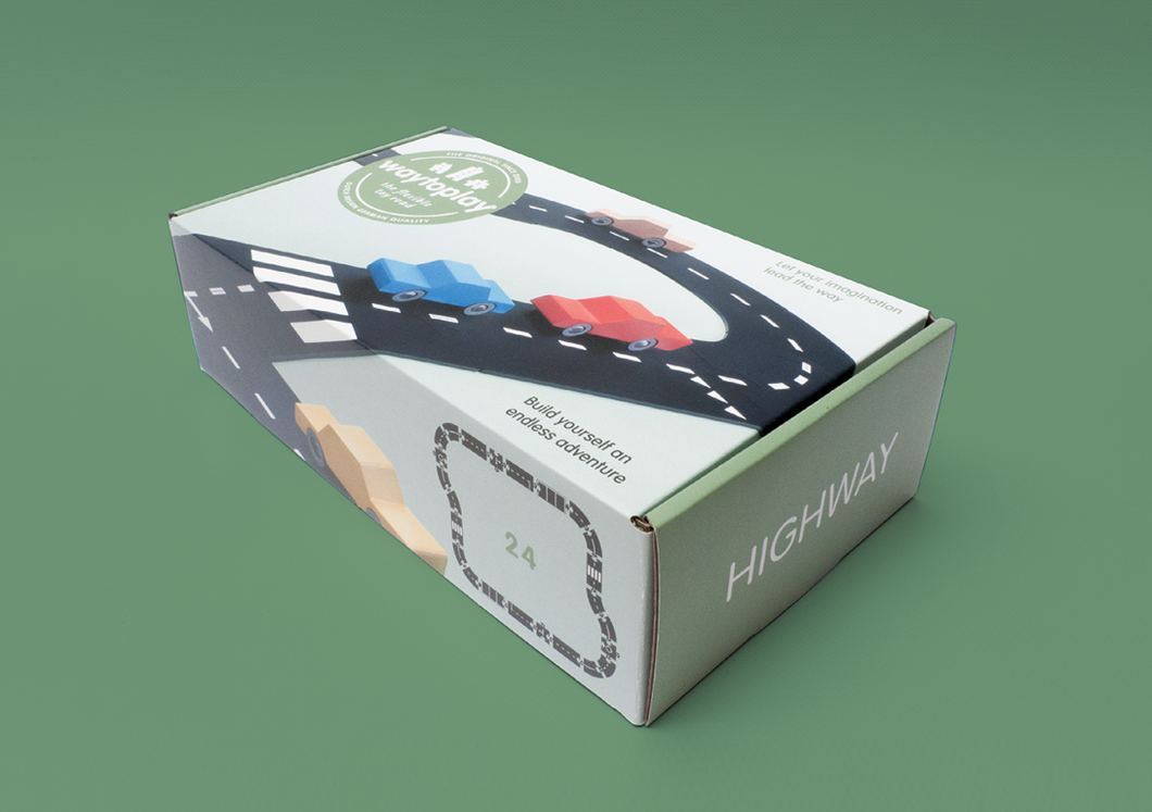 on a green background that matches the green box of the highway set. Box shows roadway and cars on it.